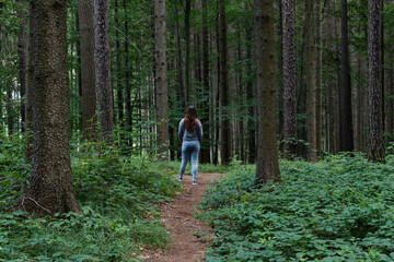 Obraz premium Girl in the forest of Czech republic back long hair jeans