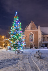 Winter in Krakow, Christmas Tree and St Francis church in the snow, night, Poland