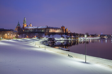 Krakow winter, night Wawel Castle over Vistula river, snow, Poland