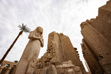 Karnak Temple Complex in Luxor. A famous ancient Egyptian temple ruin with colossal statue of...