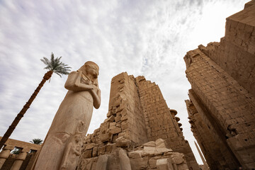 Karnak Temple Complex in Luxor. A famous ancient Egyptian temple ruin with colossal statue of...