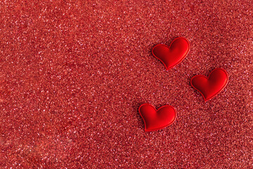 Fototapeta premium Red hearts on a red sparkle background. Minimal concept for Valentine day.