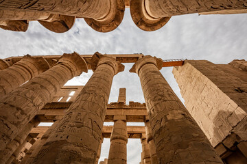 Karnak Temple Complex in Luxor Egypt. Central columns  of the Hypostyle Hall with hieroglyphics.