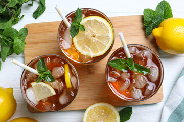 Flat lay composition with delicious iced tea on white wooden table