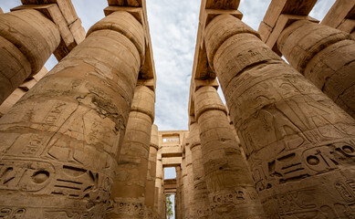 Karnak Temple Complex in Luxor Egypt. Central columns  of the Hypostyle Hall with hieroglyphics.