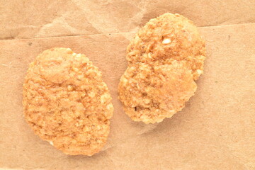 Delicious multi-grain flakes on brown paper, close-up, top view.