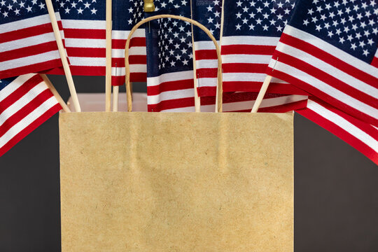 American flags in a brown paper bag for advertisement of sales.