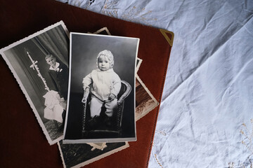 old photo albums lie on white mint tablecloth, vintage photographs of 1960, concept of family tree, genealogy, childhood memories, connection with ancestors