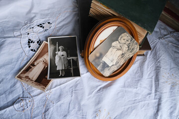 old albums lie on a white mint tablecloth, vintage photographs from 1950, concept of family tree,...