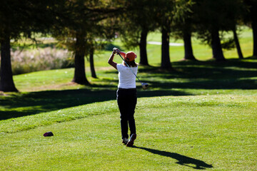 A woman playing golf on golf course in Switzerland