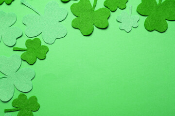 Decorative clover leaves on green background, flat lay with space for text. St. Patrick's Day...