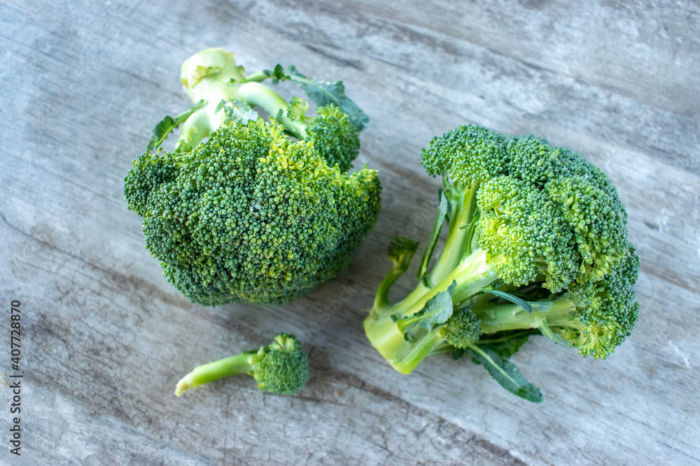 Wall mural flat lay of two green broccoli crown heads