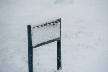 Read sign covered by snow. Impossible to read and very alone in all the snow.