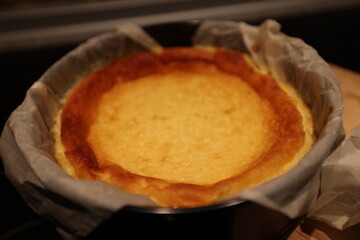 freshly baked cheesecake baked without unmoulding on the kitchen worktop