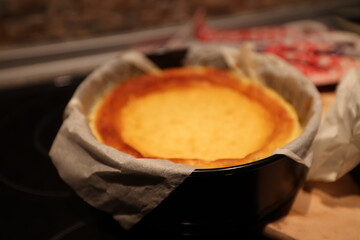 freshly baked cheesecake baked without unmoulding on the kitchen worktop