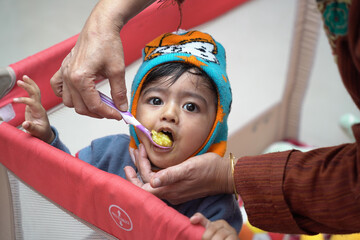 Closeup shot of an Indian mother feeding her child