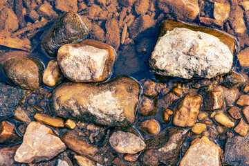 River rocks in stream in sunlight