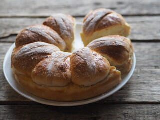 Homemade buns on a wooden background. Festive and everyday, healthy and natural food.