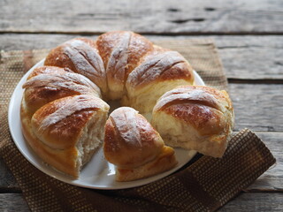 Homemade buns on a wooden background with a napkin.Festive and casual, healthy and natural food.
