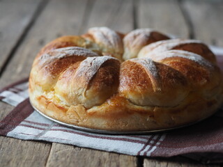 Homemade buns, on a kitchen napkin on a wooden background.Festive and casual, healthy and natural food.
