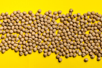 chickpea seeds on a yellow background.