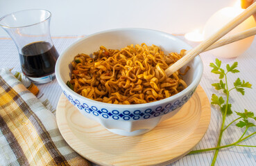 Oriental food, Chinese noodles, picked up with wooden chopsticks