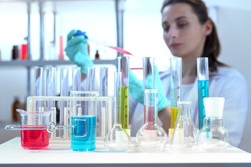 laboratory equipment, supplies, jars, bottles, cylinders, beakers. Lab assistant holding petri...