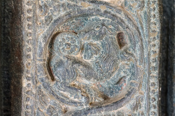 Lakkundi, Karnataka, India - November 6, 2013: Brahma Jinalaya temple. Closeup of detail featuring lamb image sculpted on gray-black stone door frame.