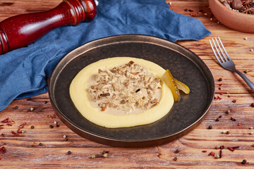 Beef stroganoff with mashed potatoes, Russian cuisine, wooden background