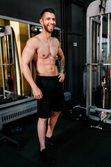 Fototapeta premium Smiling bodybuilder working out and laughing. Healthy lifestyle living