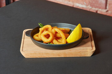 Grilled squid rings, black background