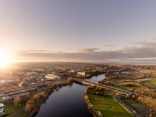 Fototapeta premium Bridge over river Corrib, Galway city, Ireland. Sunset time. Clean sky. Aerial view.