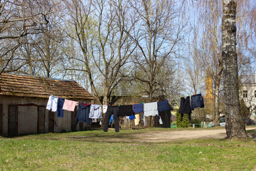Laundery drying outside. Clothes hanging on the rope in the garden.