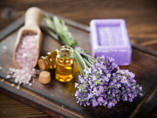 Obraz na płótnie Canvas Wellness treatments with lavender flowers on wooden table. Spa still-life.