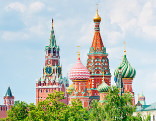 Fototapeta na wymiar Spasskaya Tower of Moscow Kremlin and the Cathedral of Vasily the Blessed (Saint Basil's Cathedral) on Red Square. Sunny summer day. Moscow. Russia