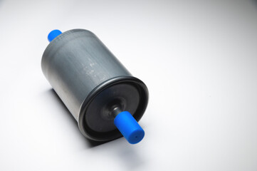New fuel filter for gasoline internal combustion engine with blue caps on a gray background. New spare parts