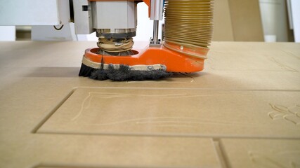 The CNC machine is working. Close-up of a numerical control machine cuts a tree. CNC tool. The...