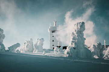 A weather station building house in the winter mountains and frozen snow nature landscape. Brocken, Harz National Park in Germany