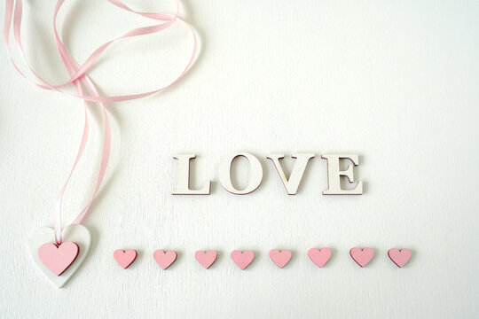 Valentine's day love concept. Pink hearts and the word love on a white background