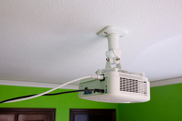 Multimedia projector hang on ceiling in a green room