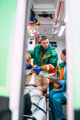Emergency medical service team with senior patient in an ambulance