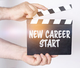On a white background, a man holds a clapperboard in his hands on which it is written - NEW CAREER...