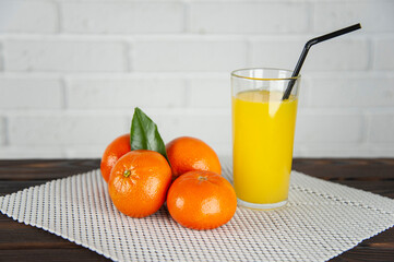 tangerines and a glass of juice on the table