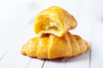 Fresh croissants on a white background,  Food and breakfast concept, puff pastry and biscuits on wooden table.