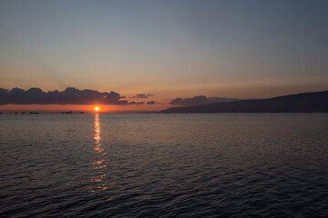 Naklejka premium Sunrise over the Mediterranian Sea. Calm and peaceful time at Ionian sea.
