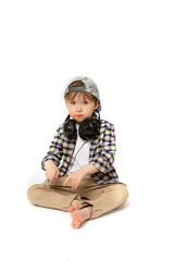 Stylish five-year-old boy in a baseball cap and shirt sits on an isolated white background. Portrait