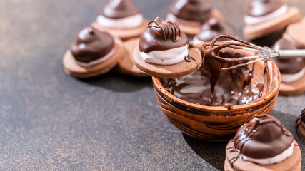 Homemade baking. Coating the pastry with melted chocolate.