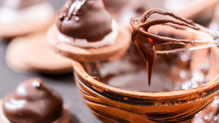 Homemade baking. Coating the pastry with melted chocolate.