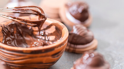 Homemade baking. Coating the pastry with melted chocolate.