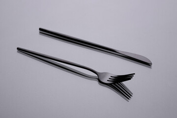Cutlery on a gray background with shadow. Table serving